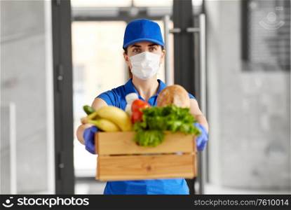 health protection, safety and pandemic concept - delivery woman in face mask and gloves holding wooden box with food. delivery woman in face mask with food in box
