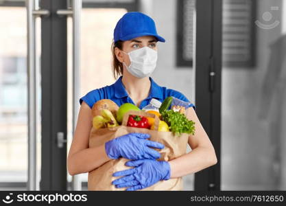 health protection, safety and pandemic concept - delivery woman in face mask and gloves holding paper bag with food. delivery woman in face mask with food in paper bag