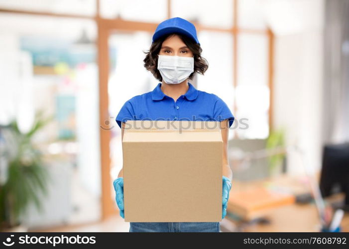 health protection, safety and pandemic concept - delivery woman in face protective mask and gloves holding parcel box over office background. delivery woman in mask with parcel box at office