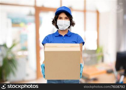 health protection, safety and pandemic concept - delivery woman in face protective mask and gloves holding parcel box over office background. delivery woman in mask with parcel box at office
