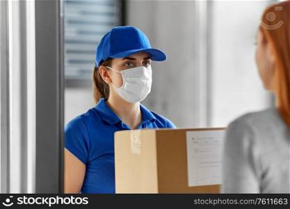 health protection, safety and pandemic concept - delivery woman in face protective mask giving parcel box to female customer at office. delivery girl in face mask giving parcel to woman