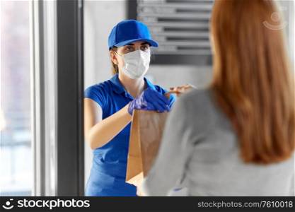 health protection, safety and pandemic concept - delivery woman in protective face mask and gloves giving paper bag with food to female customer at office. delivery girl in mask giving paper bag to woman