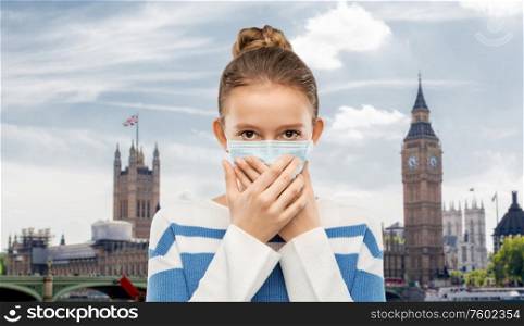 health protection, safety and pandemic concept - teenage girl in protective medical mask over big ben in london city, england background. teenage girl in protective medical mask in london