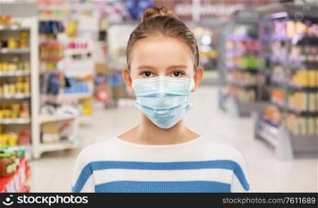 health protection, safety and pandemic concept - teenage girl in protective medical mask over supermarket or grocery store background. teenage girl in mask over supermarket