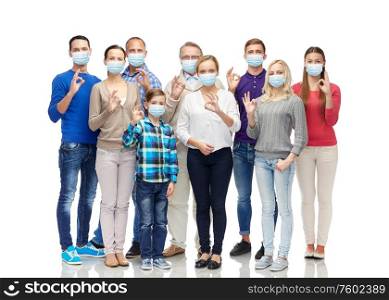 health, quarantine and pandemic concept - group of people wearing protective medical masks for protection from virus showing ok hand sign. people in medical masks showing ok hand sign