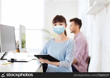health, safety and pandemic concept - asian young woman wearing protective medical mask for protection from virus disease at office. asian woman in protective medical mask at office