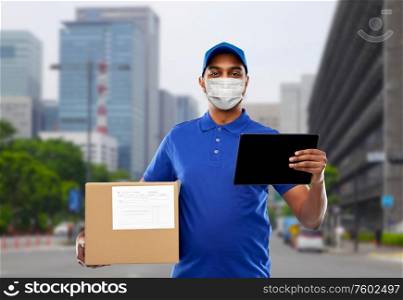 health, safety and pandemic concept - happy indian delivery man wearing face protective medical mask for protection from virus disease with tablet pc and parcel box over city street background. delivery man in mask with tablet pc and parcel box