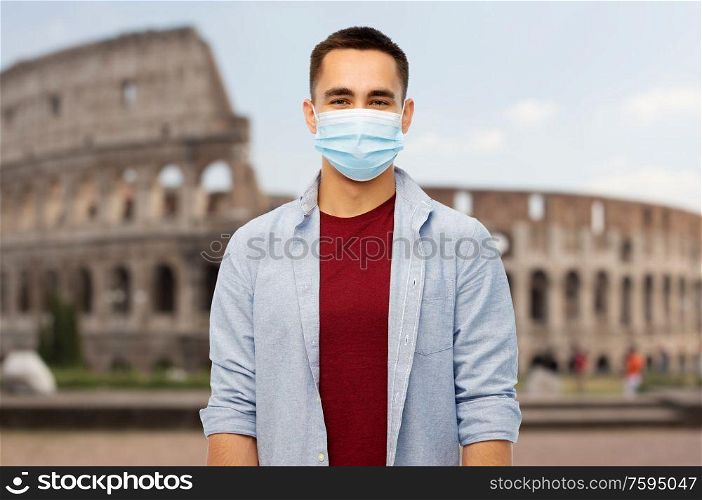health, safety and pandemic concept - man wearing protective medical mask for protection from virus disease over coliseum in rome, italy background. man wearing protective medical mask in italy