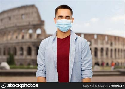 health, safety and pandemic concept - man wearing protective medical mask for protection from virus disease over coliseum in rome, italy background. man wearing protective medical mask in italy