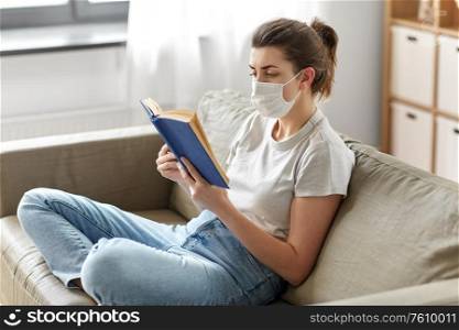 health, safety and pandemic concept - sick young woman in protective medical mask reading book at home. sick woman in medical mask reading book at home