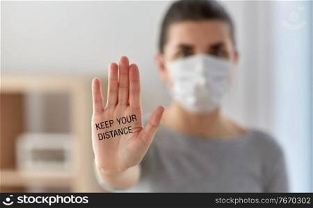 health, safety and pandemic concept - young woman in protective medical mask making stop gesture and calling to keep your distance at home. woman in mask calling to keep your distance