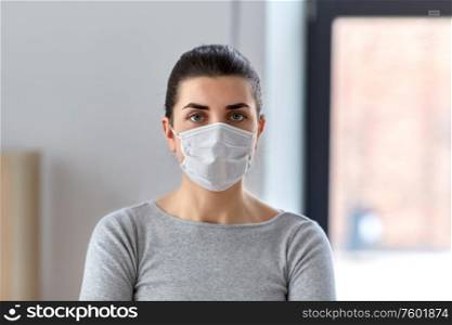 health, safety and pandemic concept - young woman wearing protective medical mask. young woman wearing protective medical mask