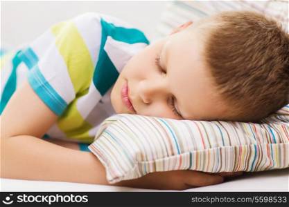 health, sleeping and dreaming concept - little boy sleeping at home
