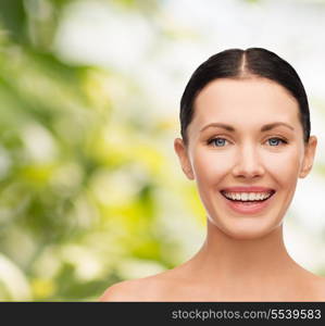 health, spa and beauty concept - clean face of beautiful young laughing woman