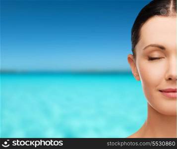 health, spa and beauty concept - clean face of beautiful young woman with closed eyes