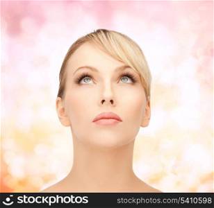 health, spa and beauty concept - face of beautiful woman with blonde hair looking up