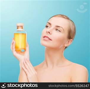 health, spa and beauty concept - lovely woman with oil bottle