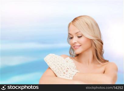 health, spa and beauty concept - smiling woman with exfoliation glove