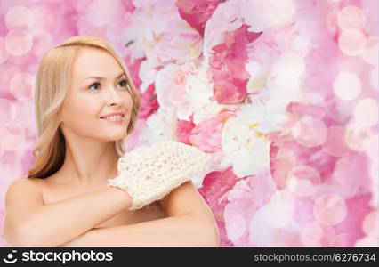 health, spa and beauty concept - smiling woman with exfoliation glove