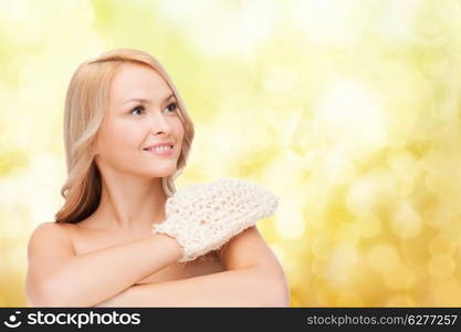 health, spa and beauty concept - smiling woman with exfoliation glove