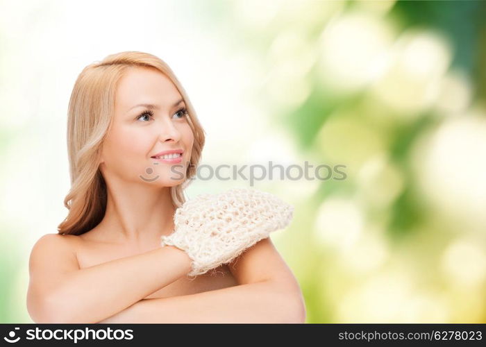 health, spa and beauty concept - smiling woman with exfoliation glove