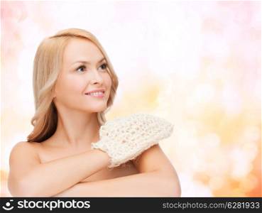 health, spa and beauty concept - smiling woman with exfoliation glove