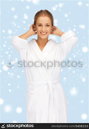 health, spa, beauty and happiness concept - beautiful woman in white bathrobe