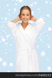 health, spa, beauty and happiness concept - beautiful woman in white bathrobe