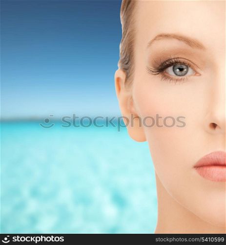 health, spa, beauty and vacation concept - close up of face of beautiful young woman