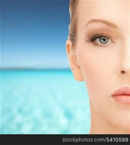 health, spa, beauty and vacation concept - close up of face of beautiful young woman