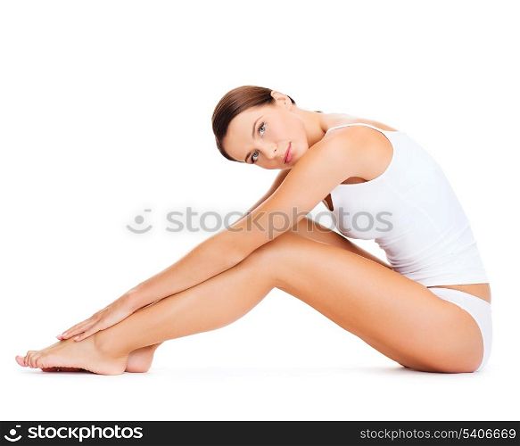 health, sport and beauty concept - sporty woman in cotton underwear doing exercises