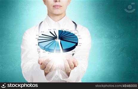 Health statistics. Close up of female doctor holding diagram in hands