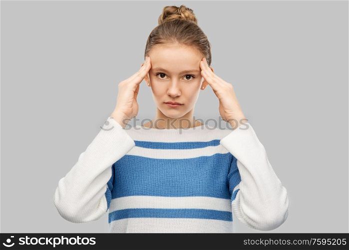 health, stress and people concept - teenage girl having headache over grey background. teenage girl having headache over grey background