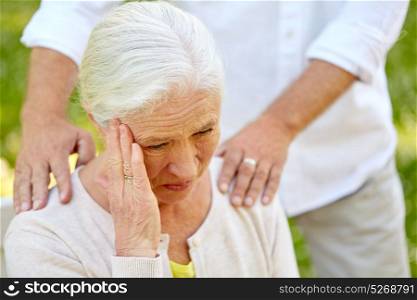 health, stress, old age and people concept - close up of senior woman suffering from headache outdoors. close up of senior woman suffering from headache