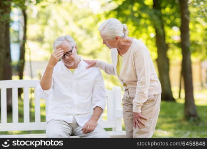 health, stress, old age and people concept - senior man suffering from headache outdoors. senior man suffering from headache outdoors