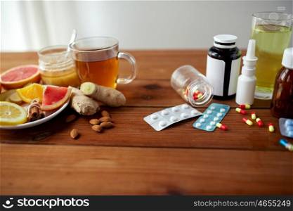 health, traditional medicine and ethnoscience concept - natural and synthetic drugs on wooden table