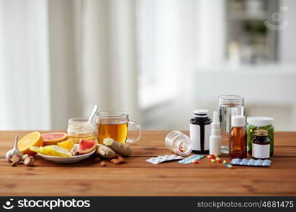 health, traditional medicine and ethnoscience concept - natural and synthetic drugs on wooden table