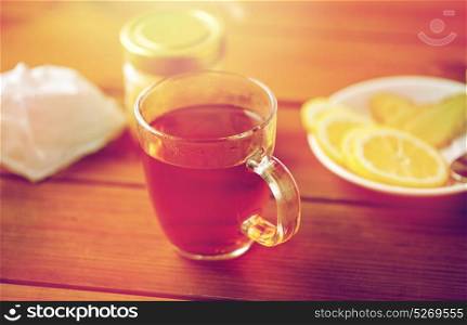 health, traditional medicine, folk remedy and ethnoscience concept - tea cup with lemon and honey. tea cup with lemon and honey