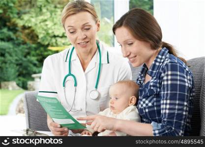 Health Visitor Giving Mother Leaflet With Advice On Baby