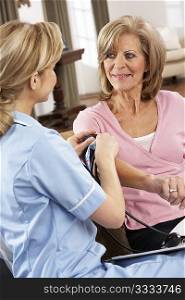 Health Visitor Taking Senior Woman&acute;s Blood Pressure