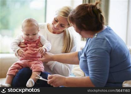 Health Visitor Talking To Mother With Young Baby