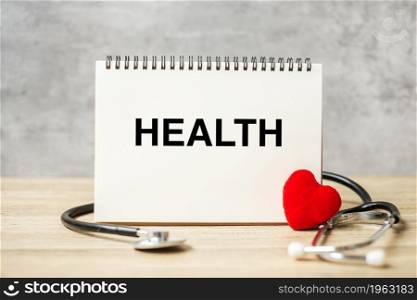 Health word on notebook and stethoscope on table. healthcare, Insurance, Wellness and medical concept