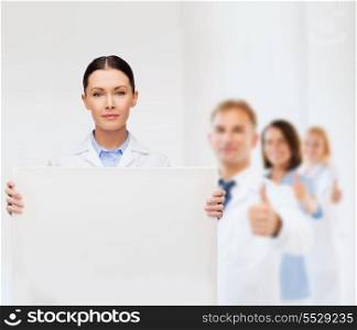 healthcare, advertisement and medicine concept - calm female doctor with white blank board