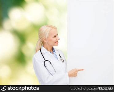 healthcare, advertisement, people and medicine concept - smiling female doctor with stethoscope showing something over natural background