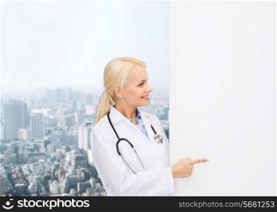 healthcare, advertisement, people and medicine concept - smiling female doctor with stethoscope showing something over city background