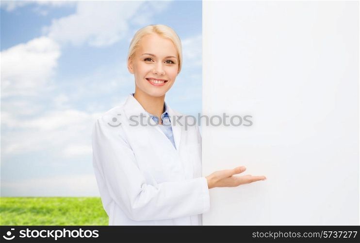 healthcare, advertisement, people and medicine concept - smiling female doctor with white blank board blue sky and grass background
