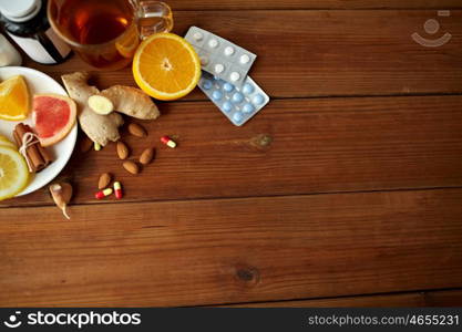 healthcare and ethnoscience concept - traditional medicine and drug pills on wooden table. traditional medicine and drugs