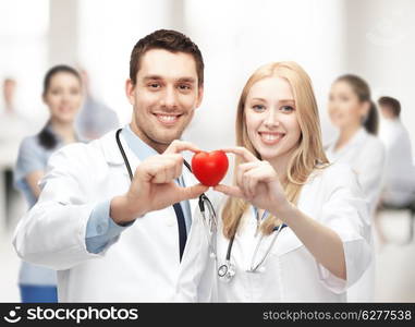 healthcare and medical concept - cardiologists with heart