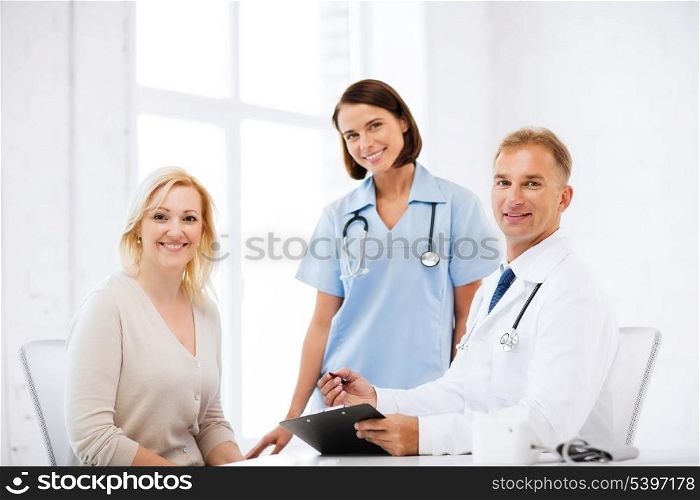 healthcare and medical concept - doctor and nurse with patient in hospital