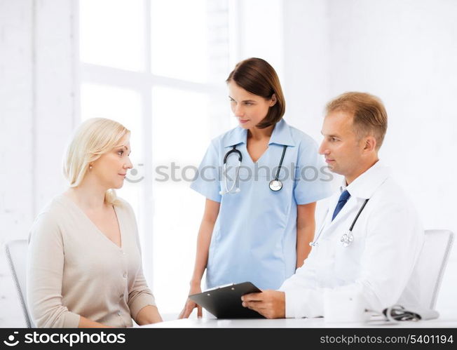 healthcare and medical concept - doctor and nurse with patient in hospital